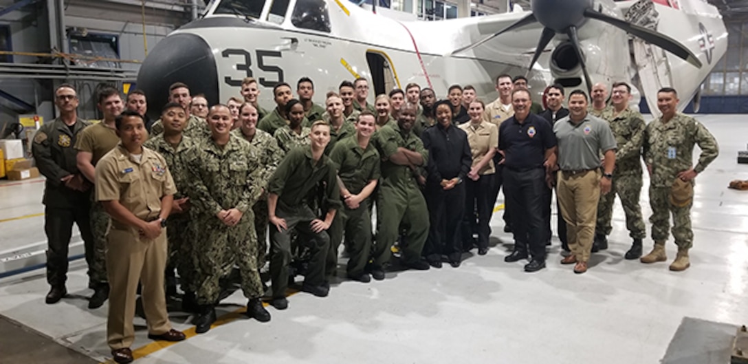 Navy and DLA members pose for photo after expediting a part