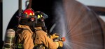 Firefighters from Joint Base San Antonio-Randolph prepare a fire hose before entering a mockup aircraft April 11, 2018 at the Camp Talon fire training grounds on JBSA-Randolph. The training offers firefighters the opportunity to train with live fire to get as close to a real-life scenario as possible.