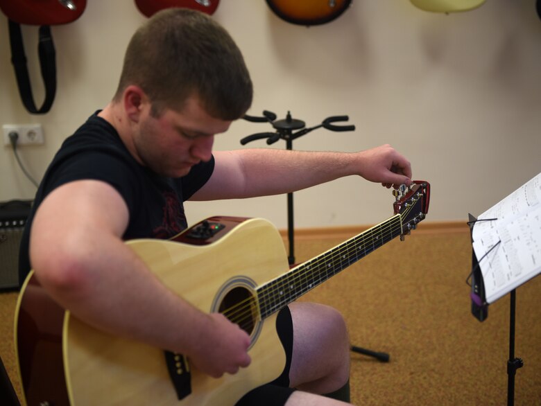 Airman 1st Class Colton Harris, 39th Communications Squadron client systems technician, tunes a guitar prior to the class held May 29, 2019, at Incirlik Air Base, Turkey. Harris started instructing the class in April to share his passion for music with other Airmen. (U.S. Air Force photo by Staff Sgt. Trevor Rhynes)