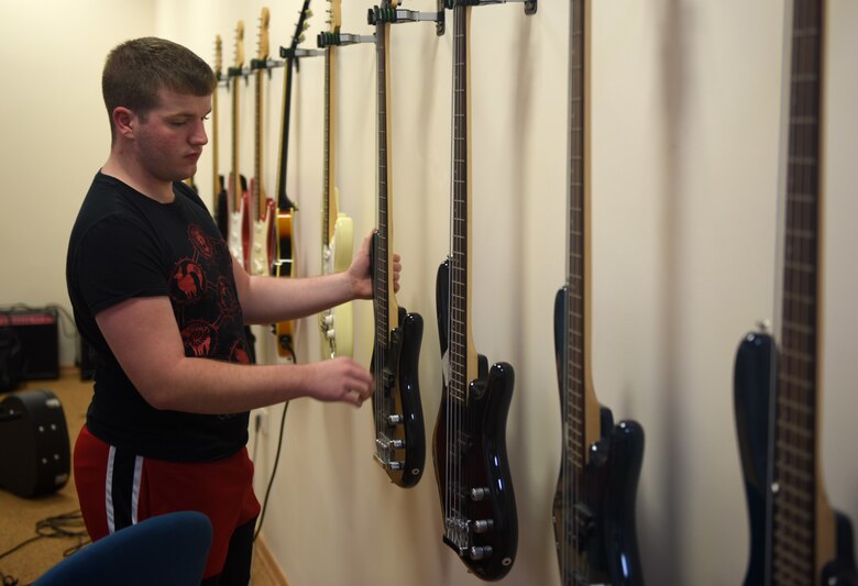 Airman 1st Class Colton Harris, 39th Communications Squadron client systems technician, picks out a guitar May 29, 2019, at Incirlik Air Base, Turkey. The Incirlik Community Center has guitars and other instruments available for Airmen to use at their facility. (U.S. Air Force photo by Staff Sgt. Trevor Rhynes)