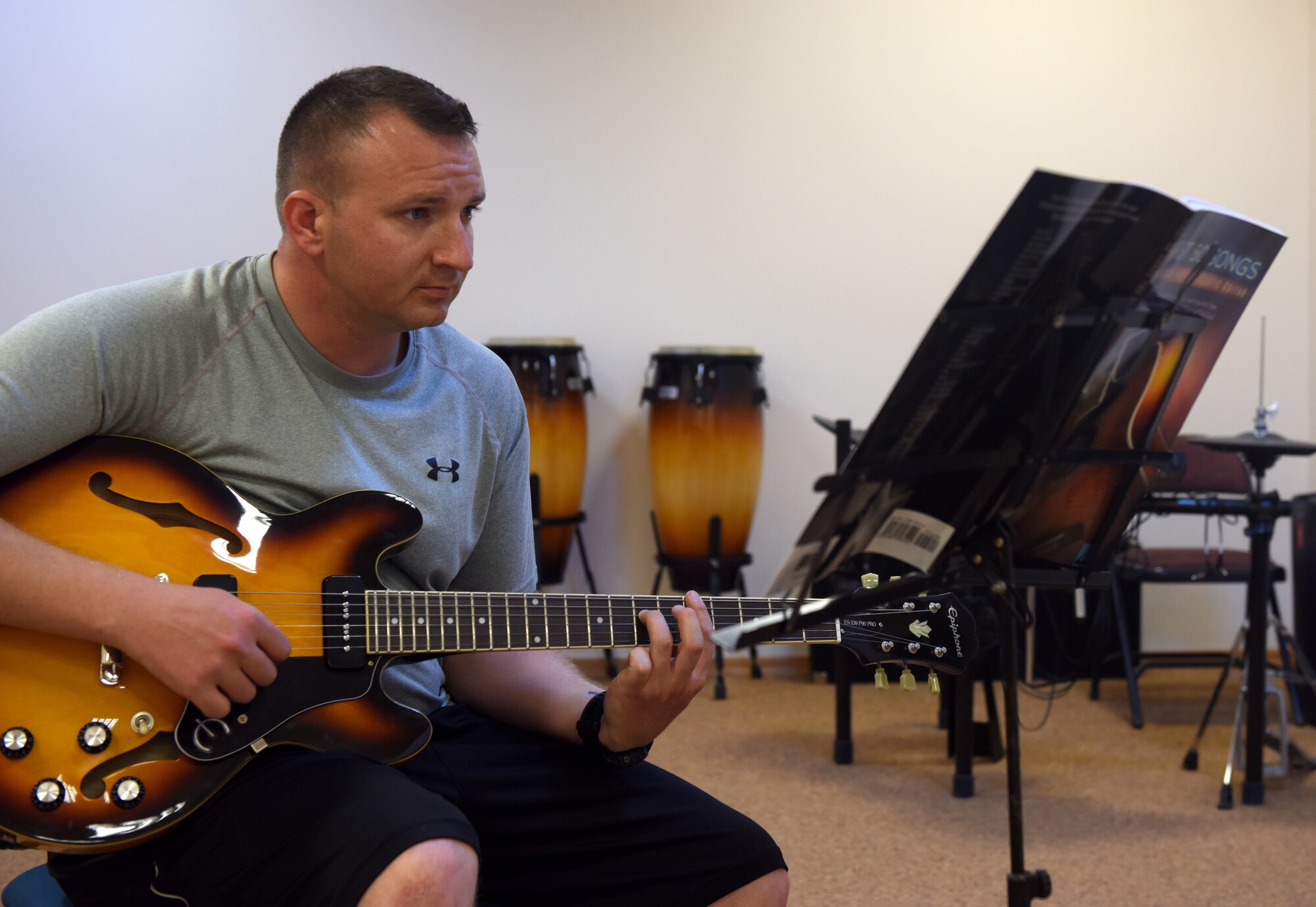 Tech. Sgt. David Eash, 39th Security Forces Squadron flight sergeant, plays a guitar during class May 29, 2019, at Incirlik Air Base, Turkey. Ranging from spin class to painting lessons, Airmen help one another pick up new hobbies and life skills during their time at Incirlik. (U.S. Air Force photo by Staff Sgt. Trevor Rhynes)