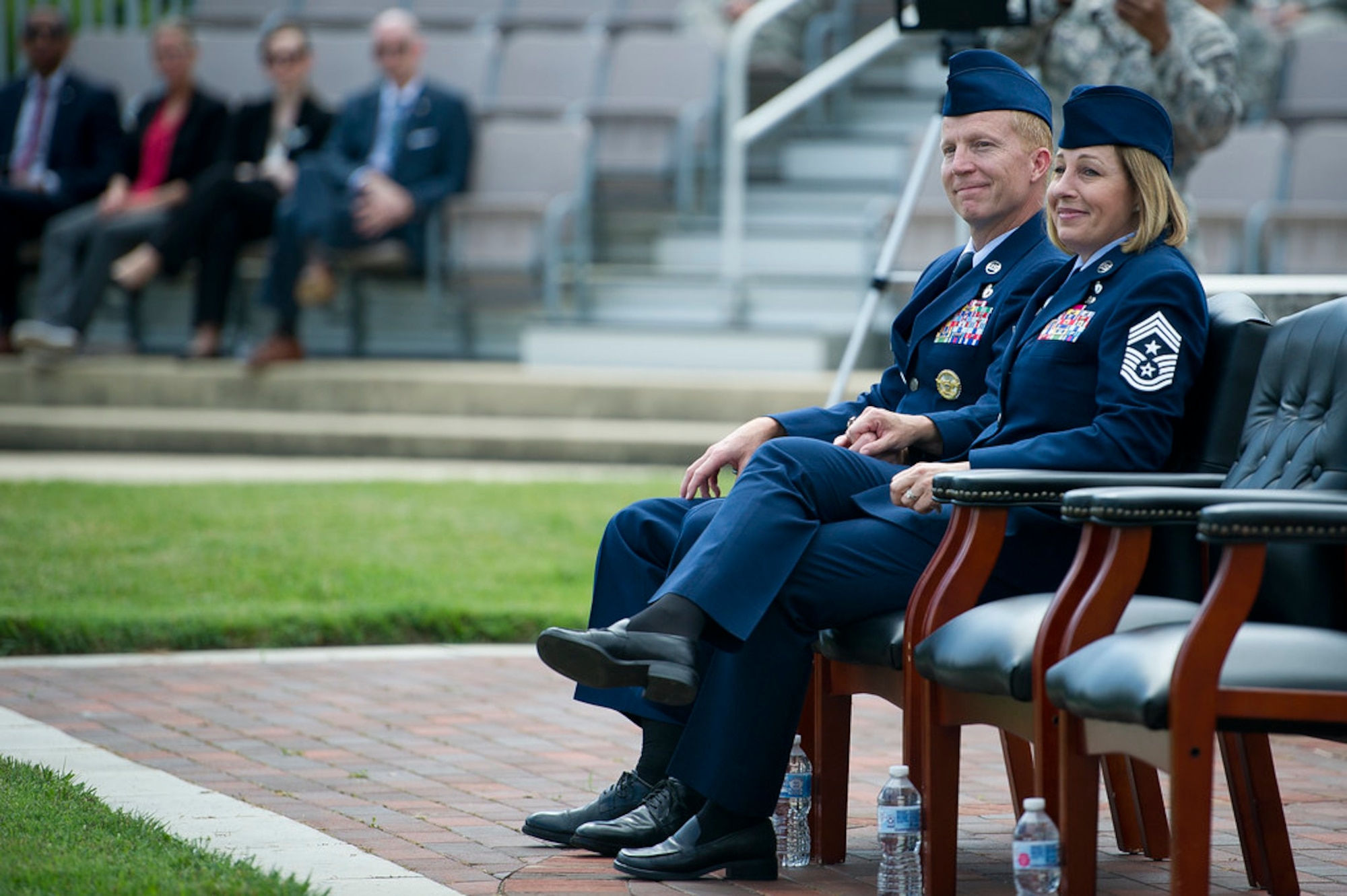 Chief Master Sgts. Melanie K. Noel, Air Force District of Washington command chief, right, and Michael D. Noel, Senior Enlisted Advisor to the Assistant to the Secretary of Defense for Public Affairs, listen to guest speakers during their combined retirement ceremony at Joint Base Anacostia-Bolling, Washington, D.C., May 31, 2019. (U.S. Air Force photo by Master Sgt. Michael B. Keller)