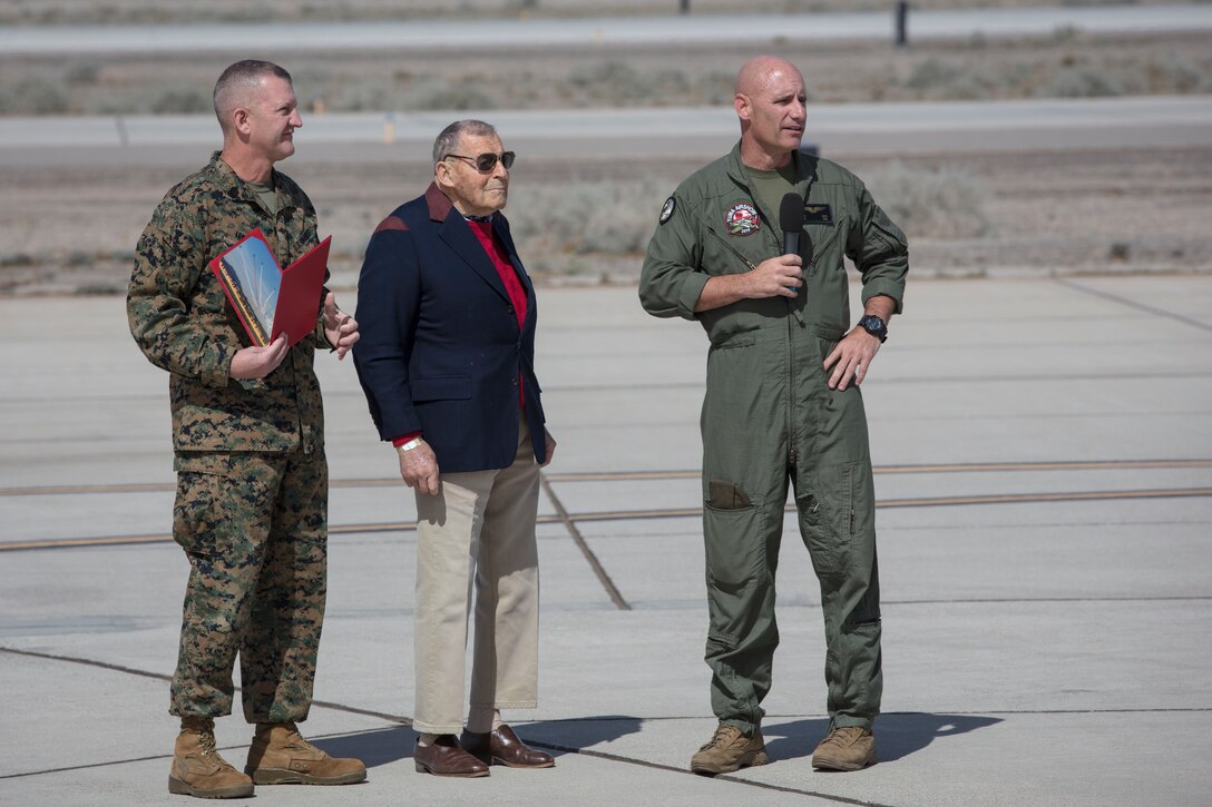 U.S. Marine Corps Col. David A. Suggs (right), commanding officer, Marine Corps Air Station (MCAS) Yuma and U.S. Marine Corps Sgt. Maj. David M. Leikwold (left), sergeant major, MCAS Yuma, present the "Air Boss" award to Mr. Jacques-Andre Istel (center) during the opening ceremony of the 2019 Yuma Twilight Show hosted by (MCAS) Yuma Ariz., March 9, 2019. The airshow is MCAS Yuma's only military airshow of the year and provides the community an opportunity to see thrilling aerial and ground performers for free while interacting with Marines and Sailors. (U.S. Marine Corps photo by Sgt. Allison Lotz)