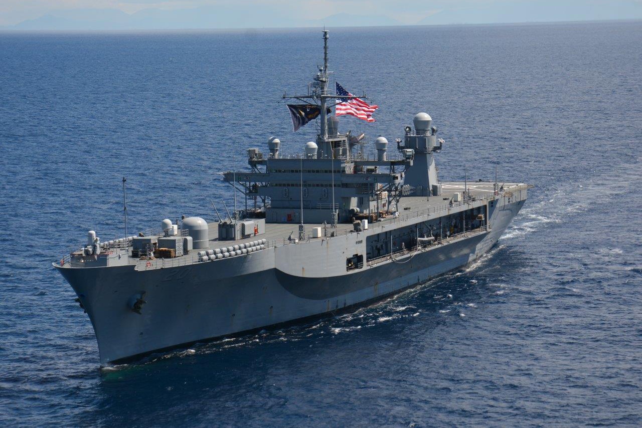 A ship passes through open water.