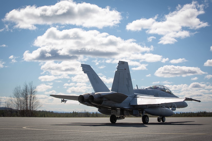 A Marine Corps fighter jet sits on the tarmac.