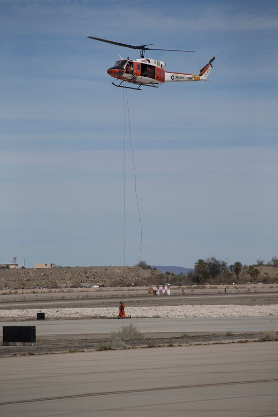 Marine Corps Air Station Yuma, Ariz., Search and Rescue HH-1N "Huey" displays their capabilities during the 2019 Yuma Airshow Saturday March 9, 2019. The "Huey" is used by the Marine Corps to provide all-weather, day or night, airborn command, control and coordination for assault support operations additionally, it is used for transportation and maritime special operations. The airshow is MCAS Yuma's only military airshow of the year and provides the community an opportunity to see thrilling aerial and ground performers for free while interacting with Marines and Sailors. (U.S. Marine Corps photo by Lance Cpl. Joel Soriano)