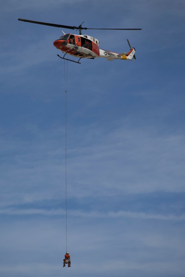 Marine Corps Air Station Yuma, Ariz., Search and Rescue HH-1N "Huey" displays their capabilities during the 2019 Yuma Airshow Saturday March 9, 2019. The "Huey" is used by the Marine Corps to provide all-weather, day or night, airborn command, control and coordination for assault support operations additionally, it is used for transportation and maritime special operations. The airshow is MCAS Yuma's only military airshow of the year and provides the community an opportunity to see thrilling aerial and ground performers for free while interacting with Marines and Sailors. (U.S. Marine Corps photo by Lance Cpl. Joel Soriano)