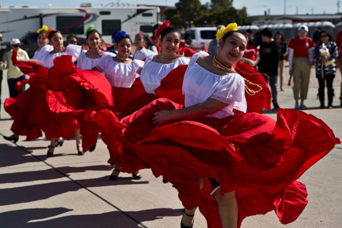 Students with Kofa Hisg School perform flkloric dances at the 2019 Yuma Airshow hosted by MArine Corps Air Station (MCAS) Yuma Ariz., Saturday, March 9, 2019. The airshow is MCAS Yuma's only military airshow of the year and provides the community an opportunity to see thrilling aerial and ground performers for free while interacting with Marines and Sailors. (U.S. Marine Corps photo by Lance Cpl. Joel Soriano)