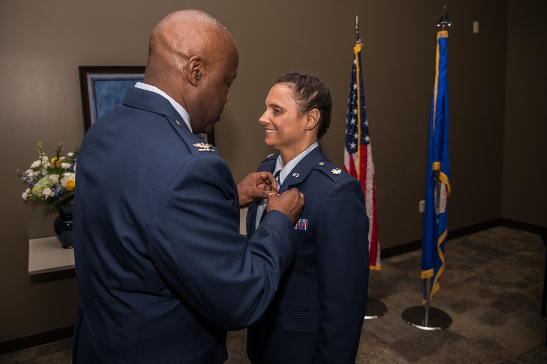 Col. Caleb King, commander, Aeromedical Staging Squadron, 932nd Airlift Wing, pins the meritorious service medal onto Lt. Col. Lori Norris, 932nd ASTS, during her retirement ceremony at Scott Air Force Base, Illinois, June 2, 2019.  Norris retired after honorably serving 28 years as a Citizen Airmen. (U.S. Air Force photo by Senior Airman Brooke Deiters)