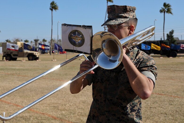 A U.S. Marine assigned to the 3rd Marine Aircraft Wing Band plays his instrument before the Marine Air Control Squadron 1 Relief and Appointment Ceremony at Marine Corps Air Station Yuma, Ariz., March 13, 2019.The Relief and Appointment ceremony is an honored product of the rich heritage of Naval tradition. The heart of the ceremony is the passing of the organizational Non-Commissioned Officer (NCO) Sword by the Activity Commander from the outgoing Sergeant Major to the new Sergeant Major, which signifies the transfer of responsibility, accountability and authority, from one individual to another. (U.S. Marine Corps photo by Lance Cpl. Joel Soriano)