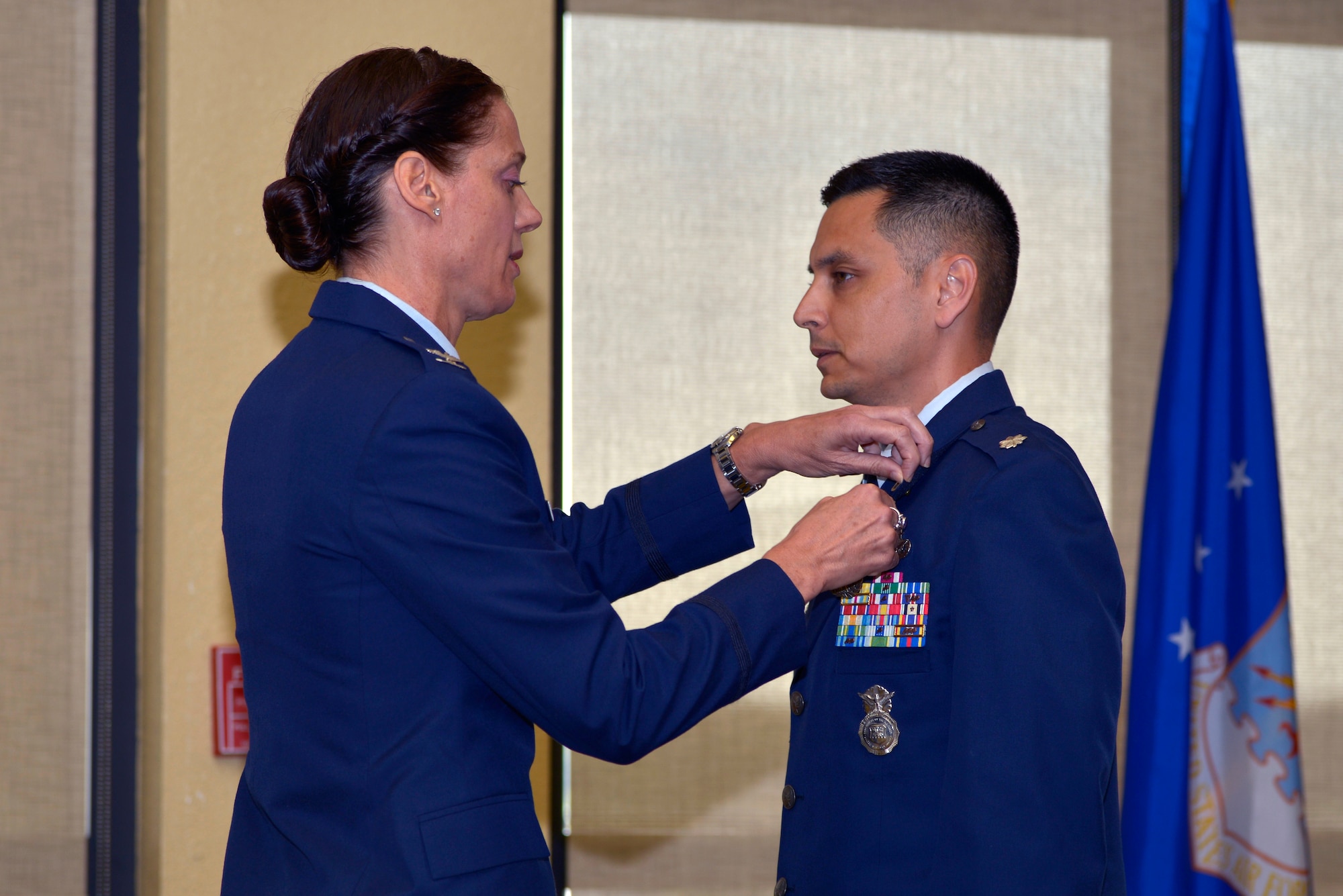 U.S. Air Force Col. Marcia L. Quigley, 81st Mission Support Group commander, presents the Meritorious Service medal to Lt. Col. Jonathon M. Murray, outgoing 81st Security Forces Squadron commander, during the 81st SFS change of command ceremony inside the Bay Breeze Event Center at Keesler Air Force Base, Mississippi, May 31, 2019. Maj. Matthew Lowe, incoming 81st SFS commander, assumed command from Murray with the passing of the guidon. The passing of the guidon is a ceremonial symbol of exchanging command from one commander to another. (U.S. Air Force photo by Airman Seth Haddix)