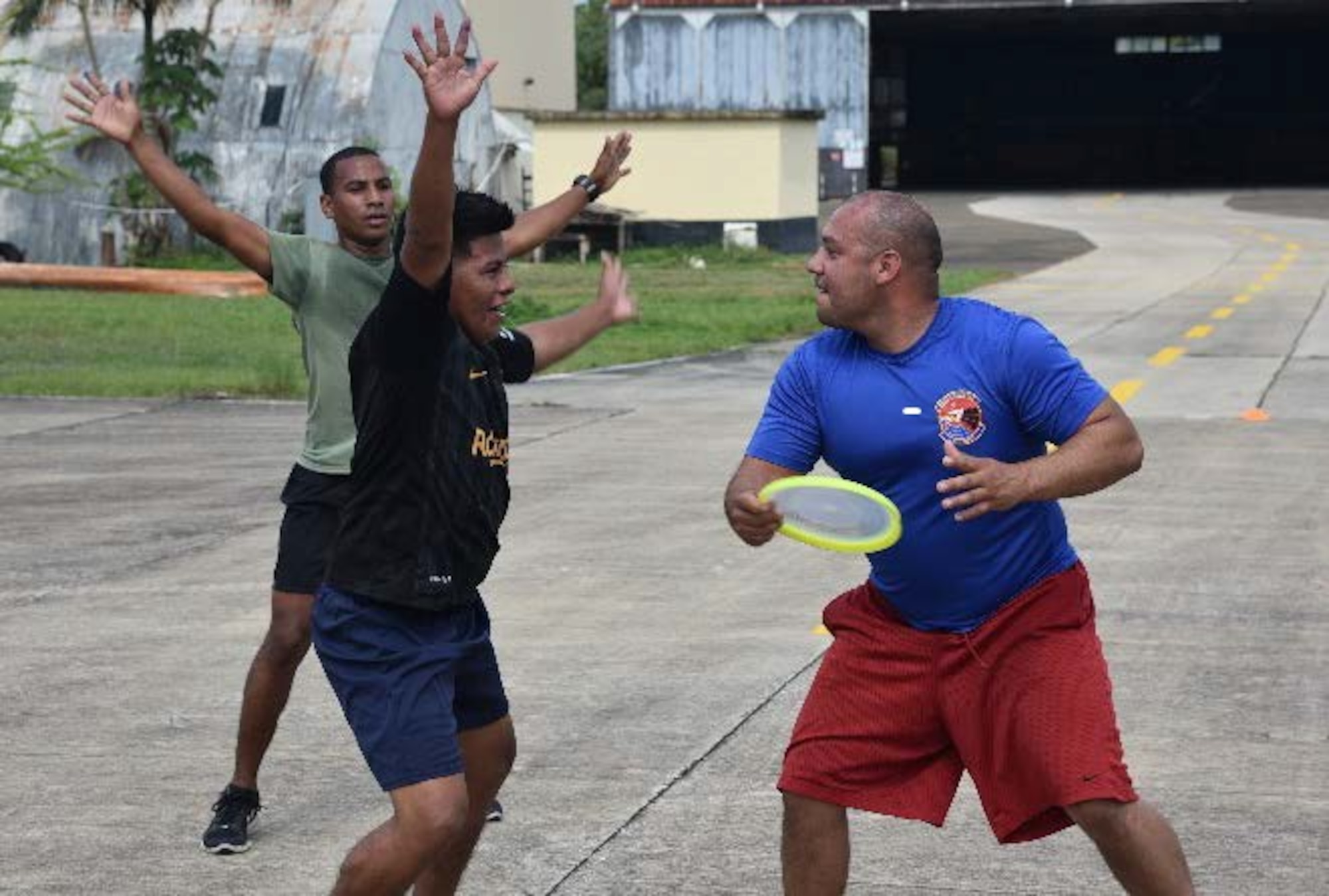 Tech. Sgt. Jose Arroyo, 571st Mobility Support Advisory Squadron air advisor, right, plays a friendly game of ultimate frisbee with partner nation students during a mobile training team mission in Belize. The 571st MSAS conducted a first-ever air, land and sea training mission with the Belize Air Wing, Belize Defence Force, and Belize Coast Guard from May 3 -18. (Courtesy photo)