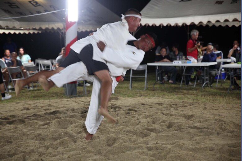 Sgt. Maj. Luis “Chino” Leiva, the sergeant major of Camp Schwab, battles with his opponent during a quarter final bout of the Henoko sumo championship June 1, 2019. The Henoko sumo competition is a century-old traditional event which follows the annual dragon boat races.