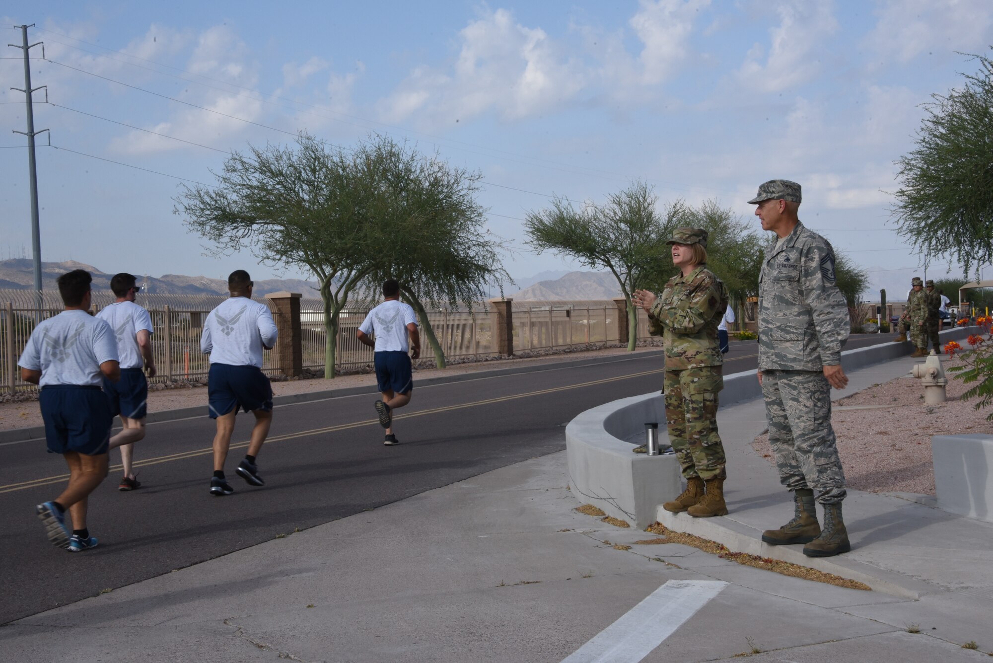 Chief Master Sgt. Rachel Landegent, 161st Air Refueling Wing mission support group superintendent, chants words of encouragement toward Airman while taking the running portion of their annual physical training assessment test June 2, 2019. Landegent enjoys inspiring Airman succeed. (U.S. Air National Guard photo by 1st Lt. Tinashe Machona)