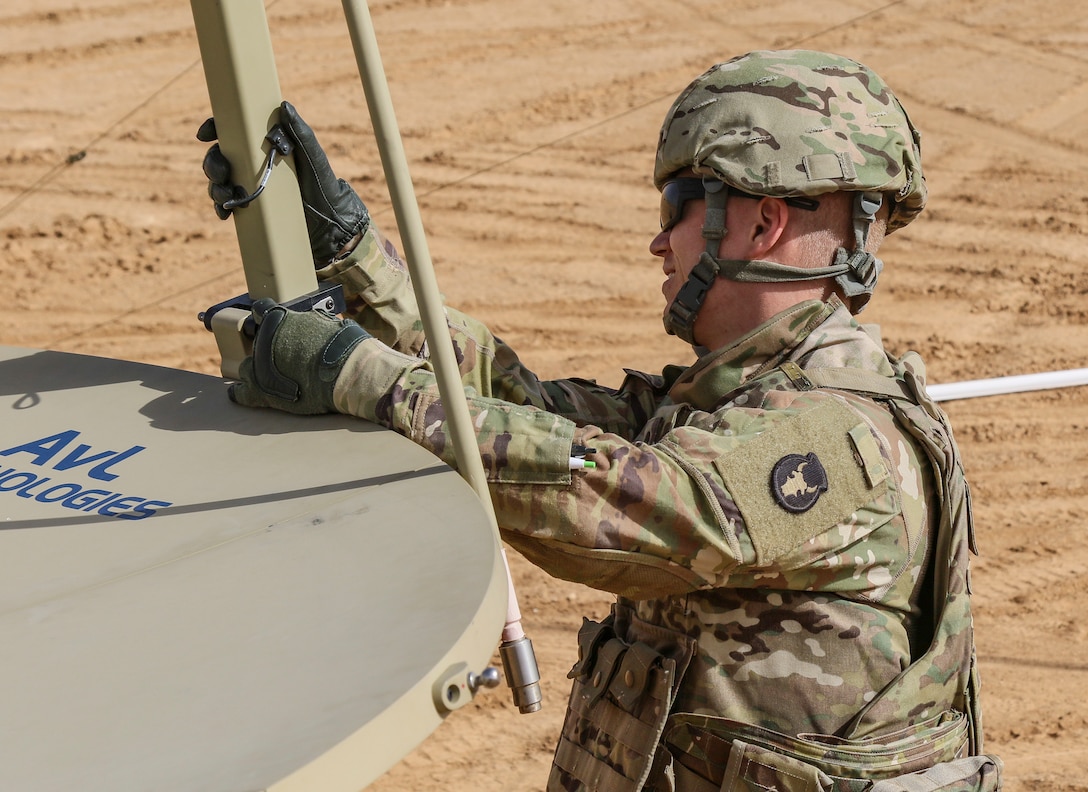 Spc. Dylan Huska, a Sipr Niper Access Point Very Small Aperture Terminal operator, of the 34th Red Bull Infantry Division, sets up SNAP, a deployable system designed to provide satellite communications in the Middle East during an emergency deployment readiness exercise in Jordan on May 3-10, 2019. This SNAP will allow the tactical command post have access to the strategic network at the location site of the EDRE. As the lead element for Task Force Spartan, the 34th Red Bull Infantry Division works to strengthen partnerships in the region by building upon and leveraging existing relationships.