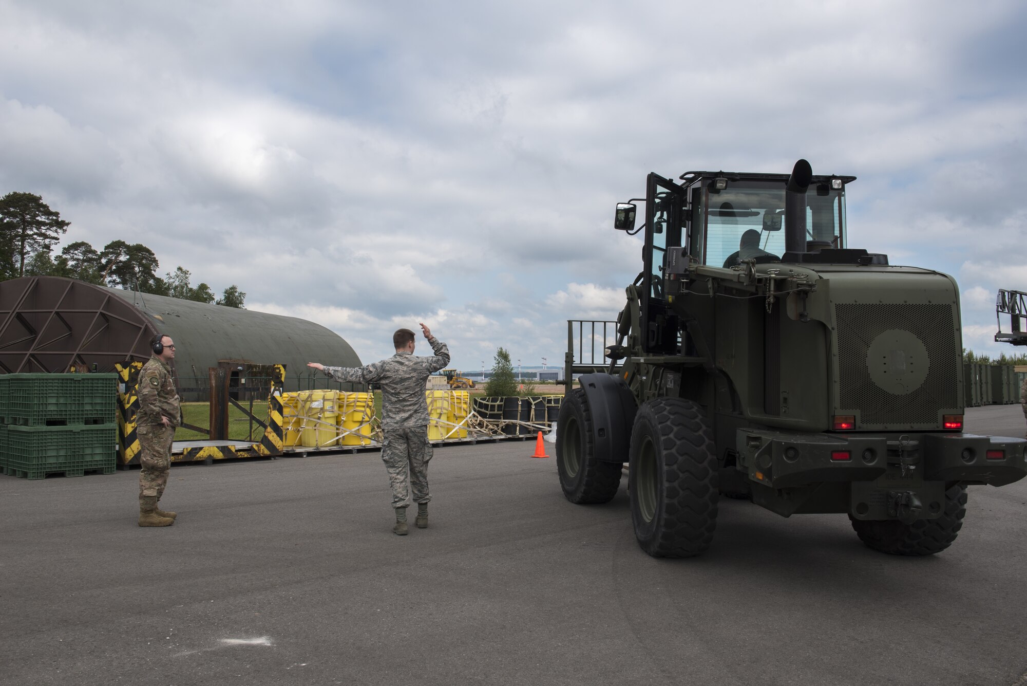 U.S. Airmen participating in the Landing Zone Safety Officer course learn how to drive a 10K forklift and also give proper signals to navigate the vehicle on Ramstein Air Base, Germany, May 29, 2019. Having hybrid Airmen who are certified allows for a smaller carbon footprint. (U.S. Air Force Photo by Airman 1st Class Kaylea Berry)