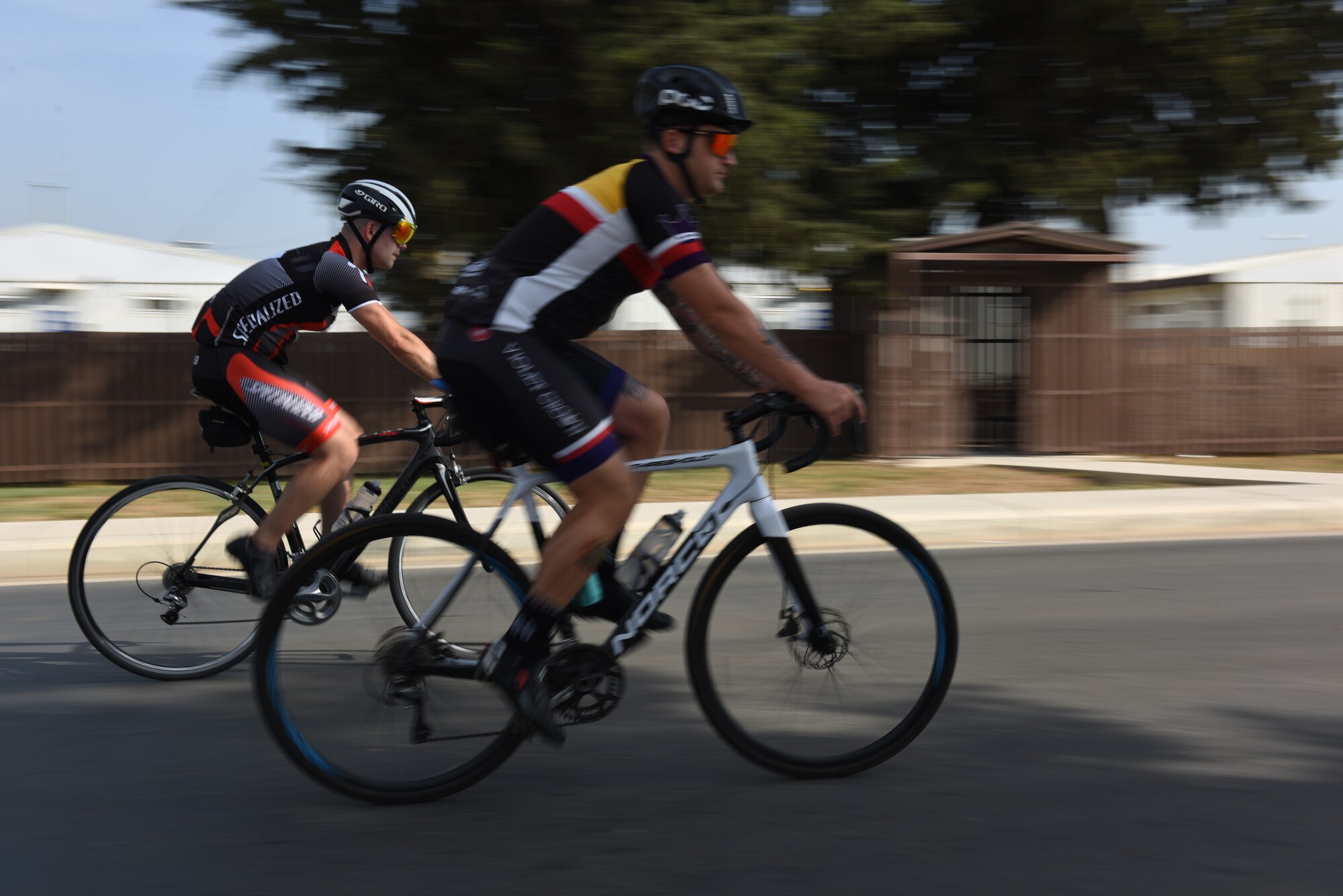 Staff Sgt. Chase Kelly, 39th Operations Support Squadron air traffic controller watch supervisor, left, and Master Sgt. Jonathan Wyatt, 39th Operations Support Squadron NCO in charge of air traffic control standardization and evaluation, right, ride their bikes June 1, 2019, at Incirlik Air Base, Turkey. The pair are part of a bike group, which is designed to help Airmen decrease stress levels and build morale. (U.S. Air Force photo by Staff Sgt. Matthew J. Wisher)