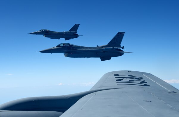 U.S. Air Force F-16 Fighting Falcons from the 457th Fighter Squadron, Fort Worth, TX fly in formation alongside a 100th Air Refueling Wing KC-135 Stratotanker from RAF Mildenhall, England, during exercise Astral Knight over the skies of Italy, June 3, 2019. AK19 is a joint, multinational exercise which aims to demonstrate the integration, coordination, and interoperability of joint existing command and control at the operation and tactical levels. (U.S. Air Force photo by Airman 1st Class Brandon Esau)