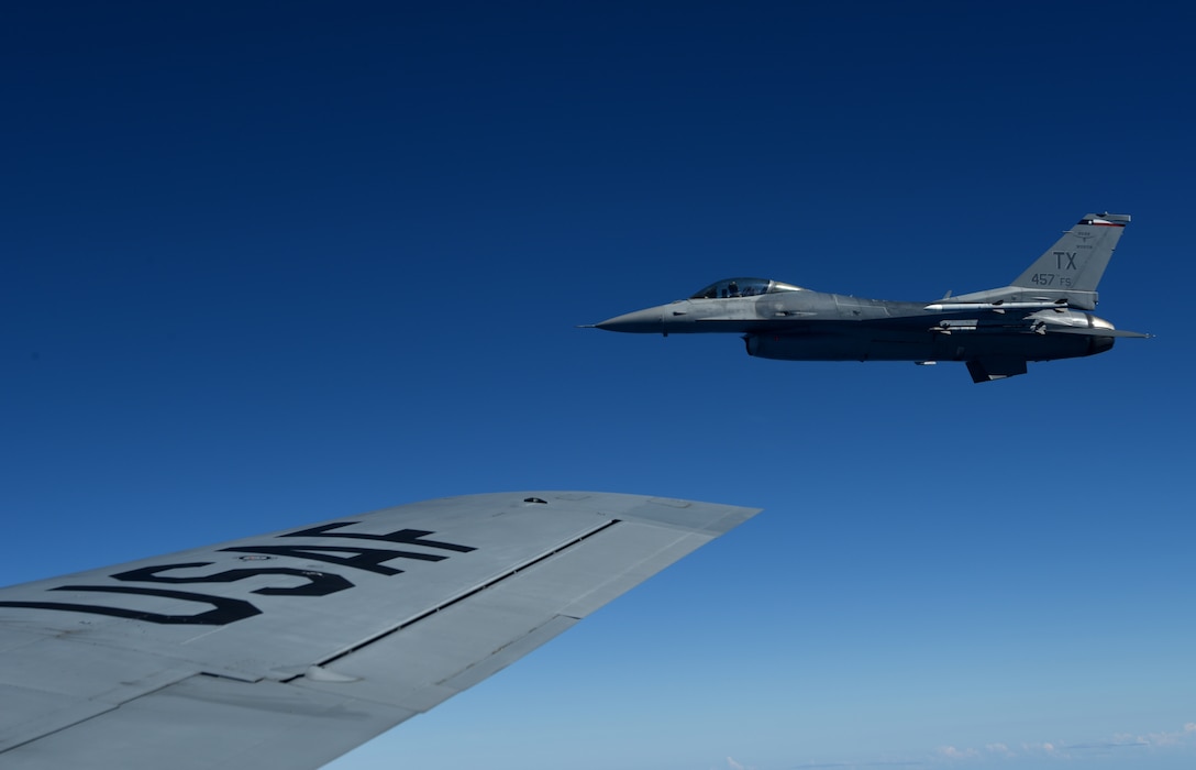 A U.S. Air Force F-16 Fighting Falcon from the 457th Fighter Squadron, Fort Worth, TX,  flies in formation alongside a 100th Air Refueling Wing KC-135 Stratotanker from RAF Mildenhall, England, during exercise Astral Knight over the skies of Italy, June 3, 2019. AK19 is a joint, multinational exercise which aims to demonstrate the integration, coordination, and interoperability of joint existing command and control at the operation and tactical levels. (U.S. Air Force photo by Airman 1st Class Brandon Esau)