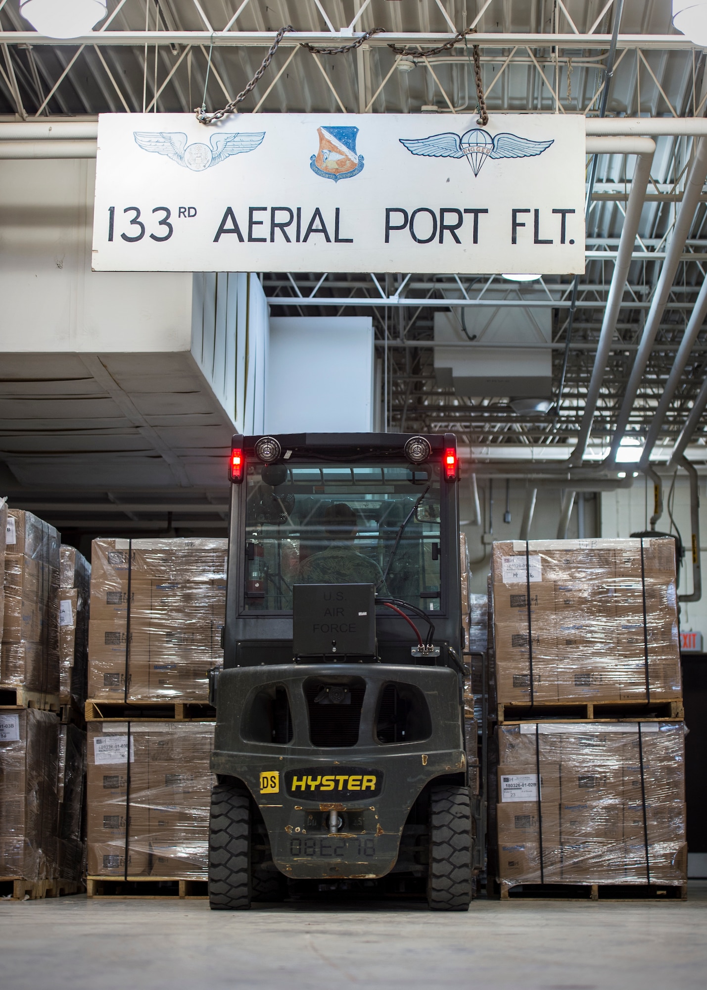 U.S. Air Force Airmen from with the 133rd Small Air Terminal load boxes of food onto pallets in St. Paul, May 18, 2019.