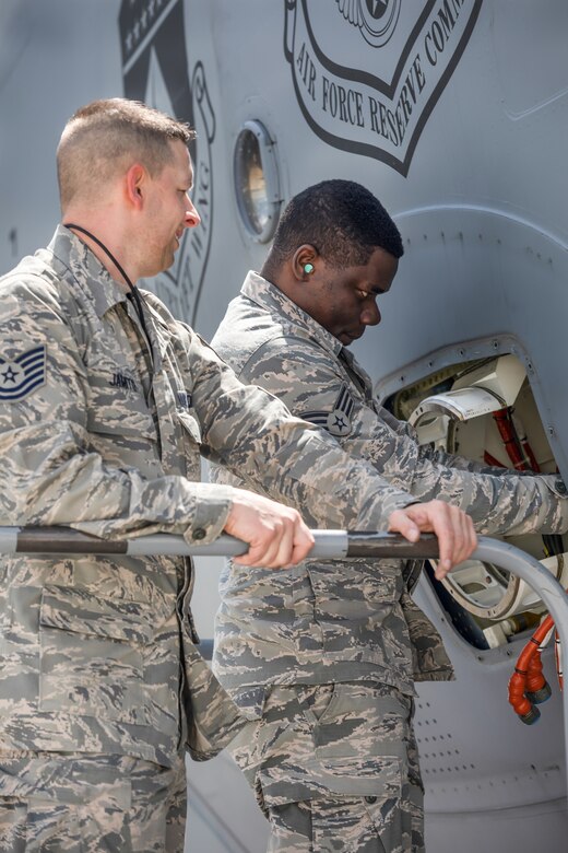 Tech. Sgt. Jeremie Jamito and Senior Airman Nuren Subair, both from the 445th Aircraft Maintenance Squadron, make repairs on a C-17 Globemaster III here, May 5, 2019.  (U.S. Air Force photo /Master Sgt. Patrick O’Reilly)