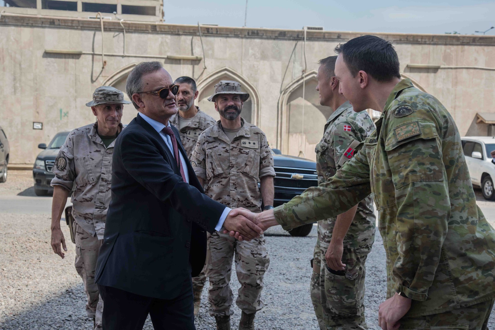 Ambassadors of different nations are greeted by members of the Combined Joint Task Force- Operation Inherent Resolve (CJTF-OIR) on Ambassador's Day on Union 3, Iraq, June 4, 2019. Key members of CJTF-OIR arranged the day in order to talk to ambassador's of the coalition's nations on the progress of the partnership established by CJTF-OIR and the population of Iraq. The Coalition continually reviews its force levels in Iraq in order to achieve the job that has been requested of us by the Government of Iraq. (Portions of this image have been blurred to protect operational security) (U.S Army Photo by Spc. Adrian Pacheco)