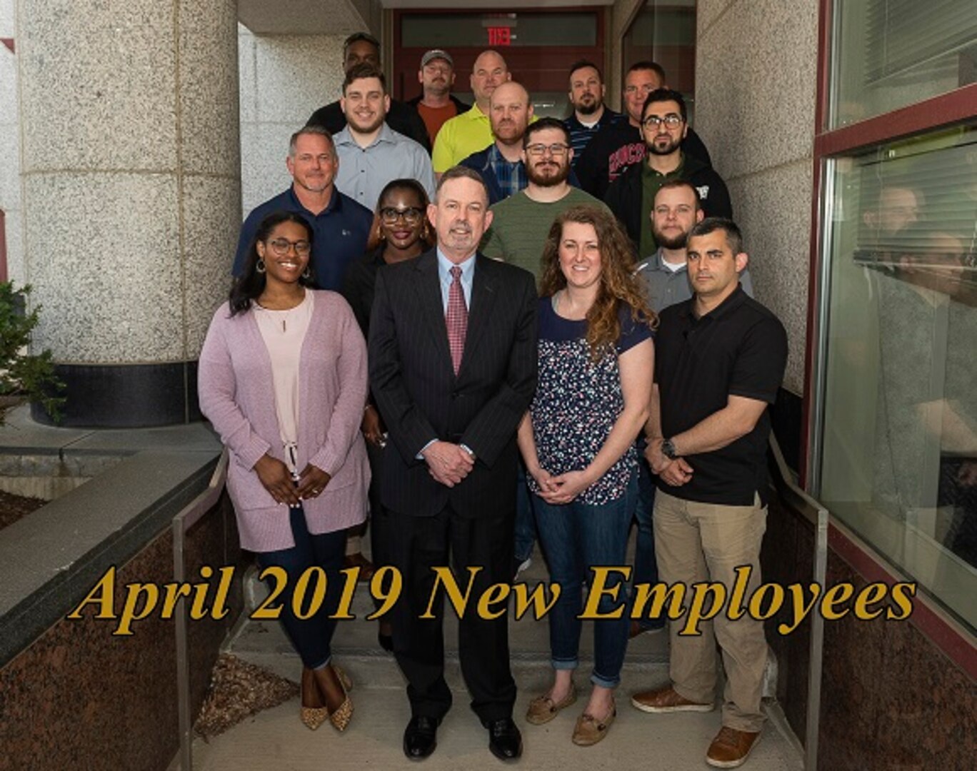 Group photo of 16 new employees with Mr. Warren for the April 2019 NEO
