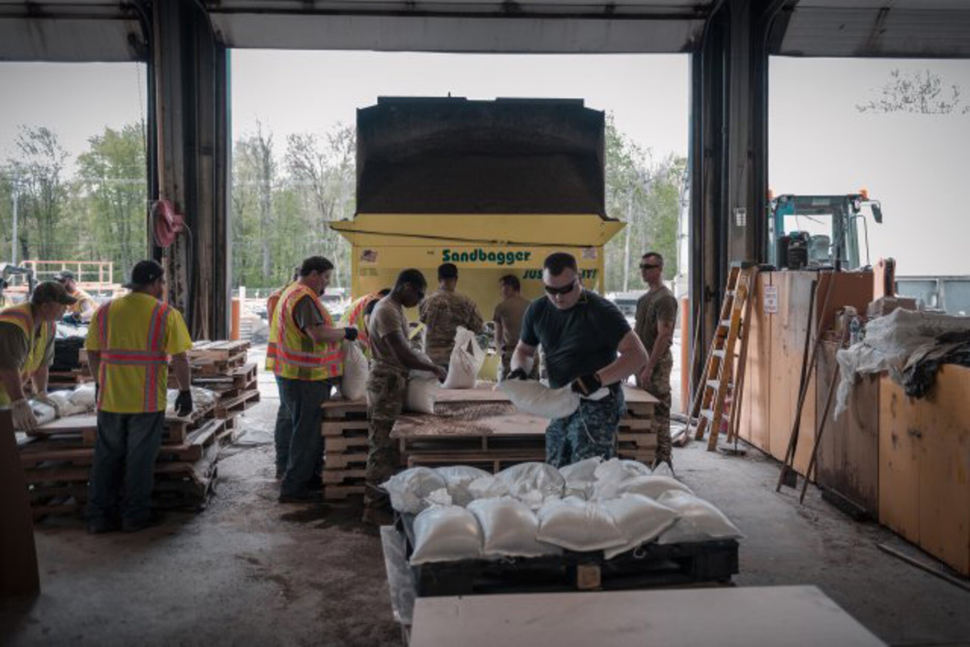 Service members assigned to the New York Army National Guard and New York Naval Militia, along with employees from the Department of Transportation, fill sandbags at Sodus Point, N.Y., May 20, 2019. The sandbags are being used to mitigate the effects of flooding along Lake Ontario as a result of rising water levels, that followed up with the activation of the troops by Gov. Andrew Cuomo.