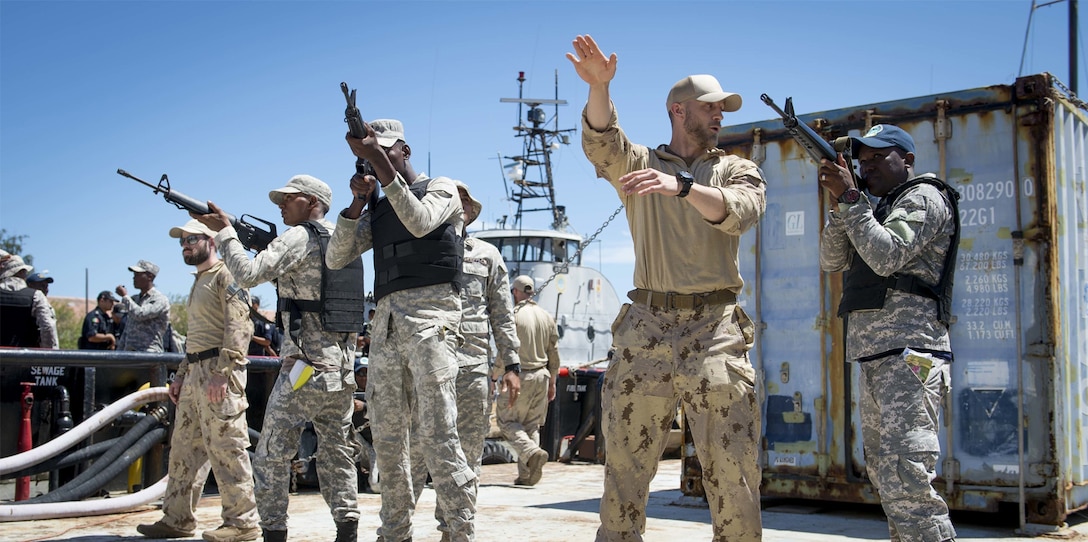 A member of the Canadian Naval Tactical Operations Group provides Dominican Republic Navy personnel with techniques on how to secure the perimeter of a ship