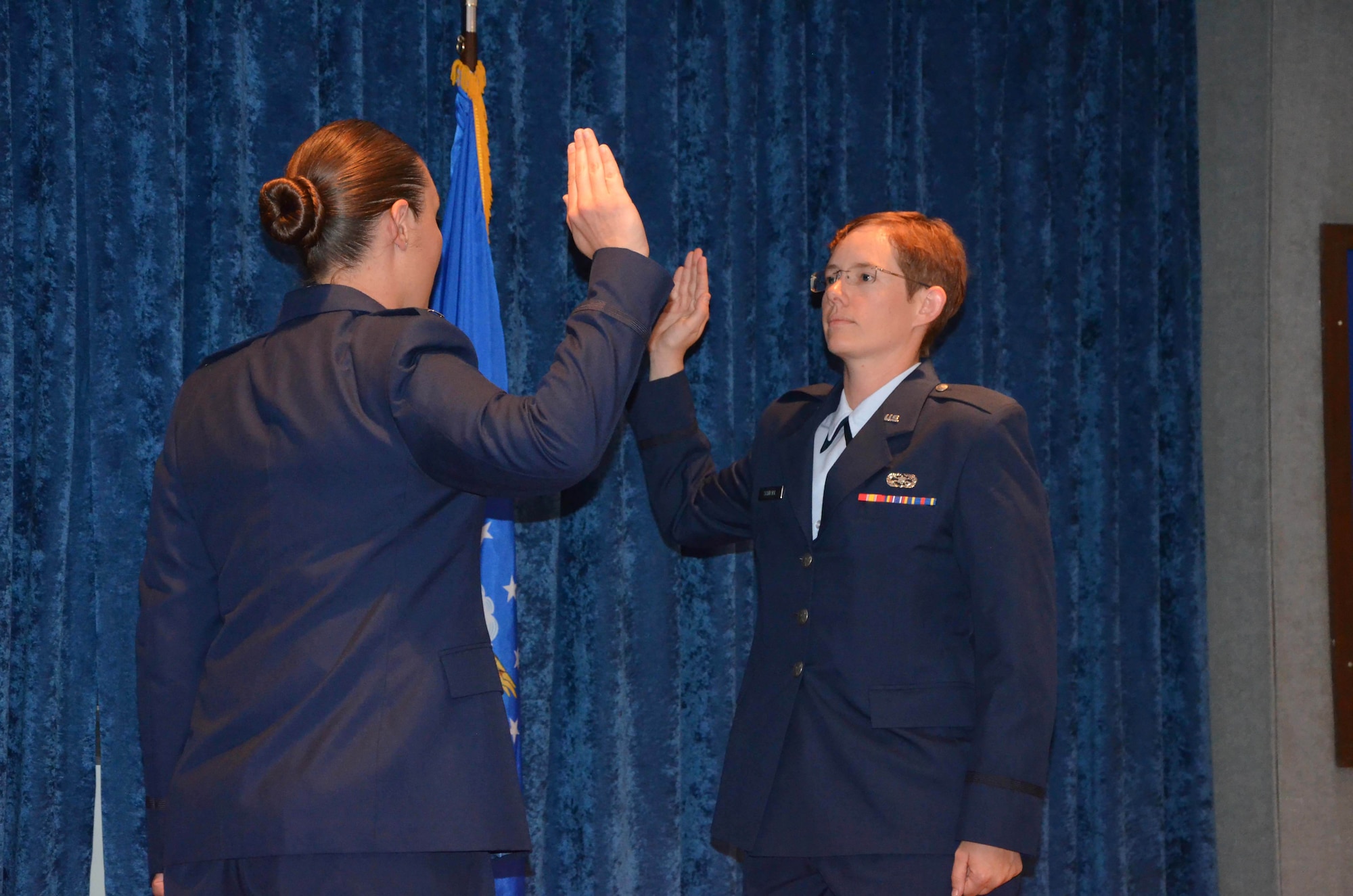 1st Lt. Ashley M. Dalessandro (left) administers the commissioning oath to Officer Trainee Cynthia A. Schroll during a ceremony at Maxwell Air Force Base, Ala.  Schroll, a former E-3 with a doctorate in analytical chemistry, joined the officer ranks after completing Air Force Officer Training School May 31, 2019.  (U.S. Air Force photo by Susan A. Romano)