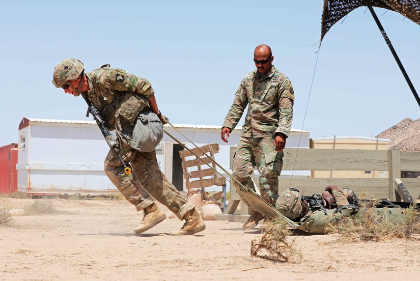 Staff Sgt. David Schwigen, an infantry Soldier with 1st Battalion, 327th Infantry Regiment, 1st Brigade Combat Team, 101st Infantry Division, moves a simulated casualty 50 meters to a casualty collection point during Expert Infantryman Badge testing at Camp Buehring, Kuwait on Thursday, May 30, 2019. Infantry Soldiers throughout the U.S. Army Central area of operations were invited to participate in EIB testing hosted by the 3rd Armored Brigade Combat Team, 4th Infantry Division.