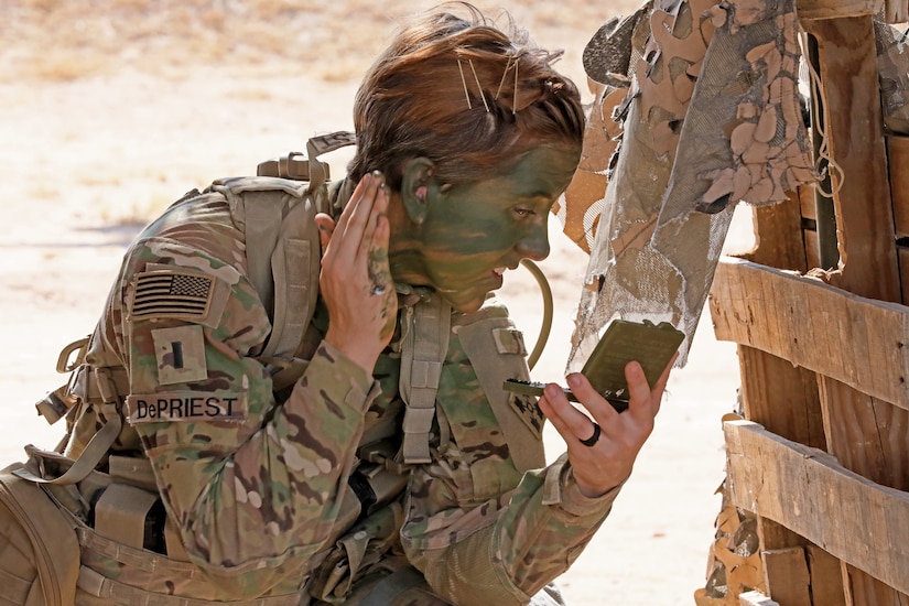 1st Lt. Shelby DePriest, an infantry Soldier with 1st Battalion, 8th Infantry Regiment, 3rd Armored Brigade Combat Team, 4th Infantry Division, applies camouflage face paint during patrol lane testing for the Expert Infantryman Badge at Camp Buehring, Kuwait on Friday, May 31, 2019. Upon completion of testing, DePriest became the first female EIB awardee in the 4th Infantry Division.