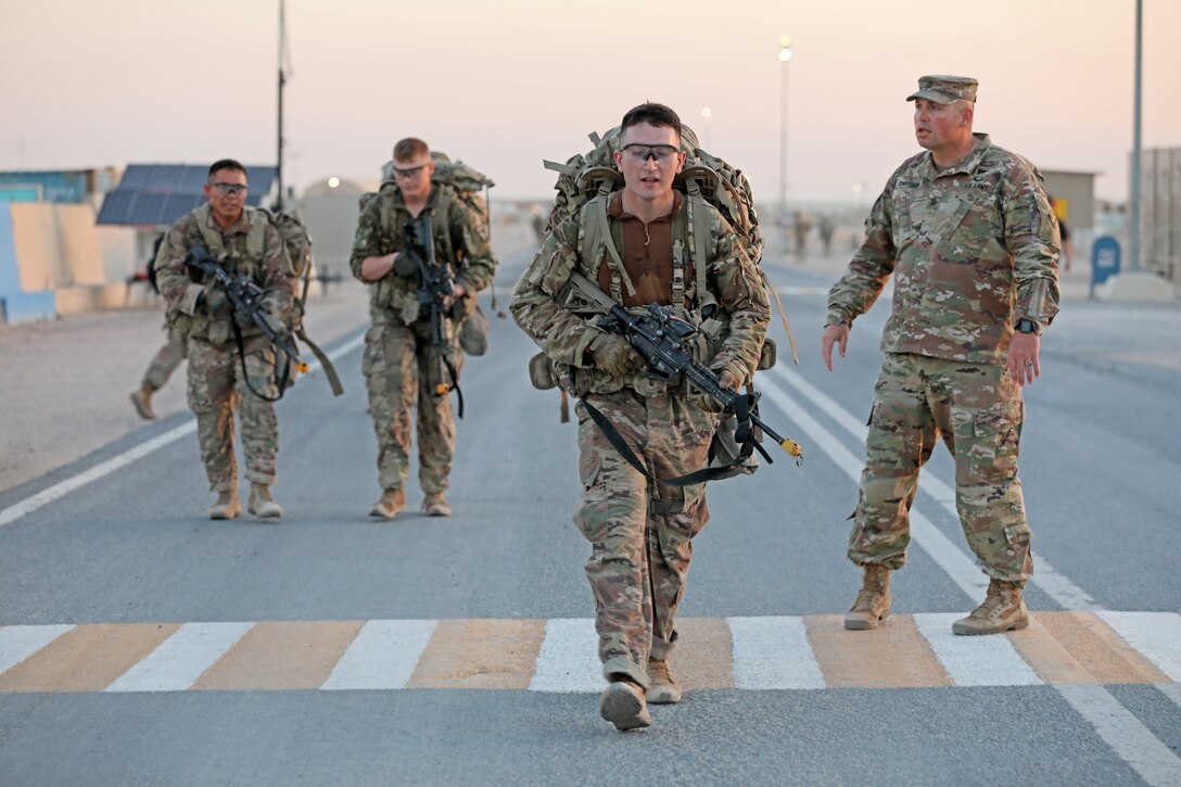 Infantry Soldiers deployed in the U.S. Army Central area of operations finish a 12-mile ruck march in less than three hours as the final event in Expert Infantryman Badge testing at Camp Buehring, Kuwait on Saturday, June 1, 2019. The ruck march, in addition to a final weapons test and gear layout, concluded a week-long testing event in which 61 infantry Soldiers earned their EIB.