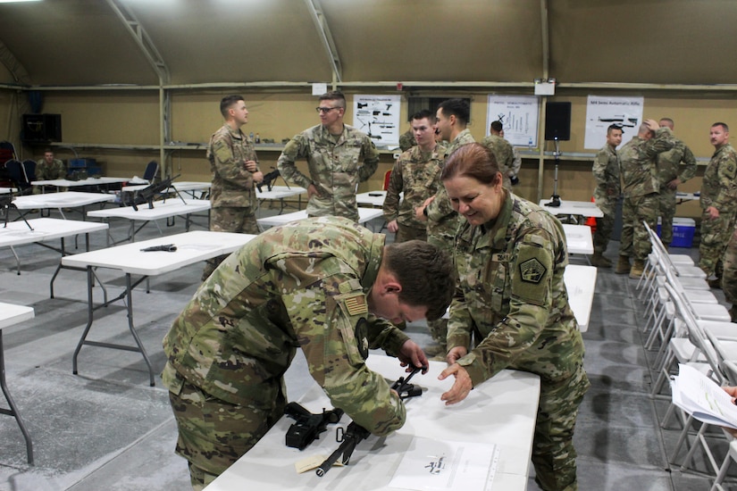 Command Sgt. Maj. Sheryl Lyon, U.S. Army Cyber Command senior enlisted leader, coaches U.S. Air Force Staff Sgt. Shaun Trainor, a client systems technician for the 386th Expeditionary Communications Squadron, on the assembly of the M4 carbine during the U.S. Army Central  2019 Best Cyber Warrior Competition, at Camp Arifjan, Kuwait, May 14, 2019. The event was the first joint, multinational competition, and highlighted the teamwork required to defend the U.S. in the cyber domain.