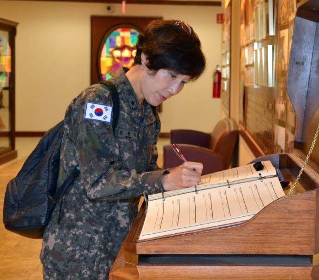 Republic of Korea Army Brig. Gen. Myoung-ok Kwon, superintendent for the Korea Armed Forces Nursing Academy signs the distinguished visitor log book at the U.S. Army Medical Department Center & School, Health Readiness Center of Excellence’s International Military Student Office 22 years after she graduated from what is now the Captains Career Course at the HRCoE at Joint Base San Antonio-Fort Sam Houston.