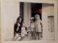 Joseph Green on the steps of his home with his
mother and sisters in Zahra, Tunisia around 1971.