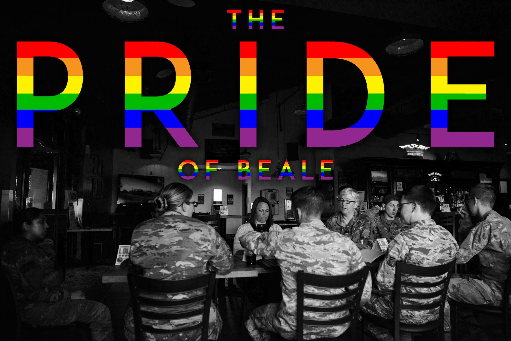 Multiple members of the Beale Air Force Base LGBTQ group gather at their usual meeting spot at the base pub. The graphic with rainbow letters saying "The Pride of Beale" is superimposed above them.