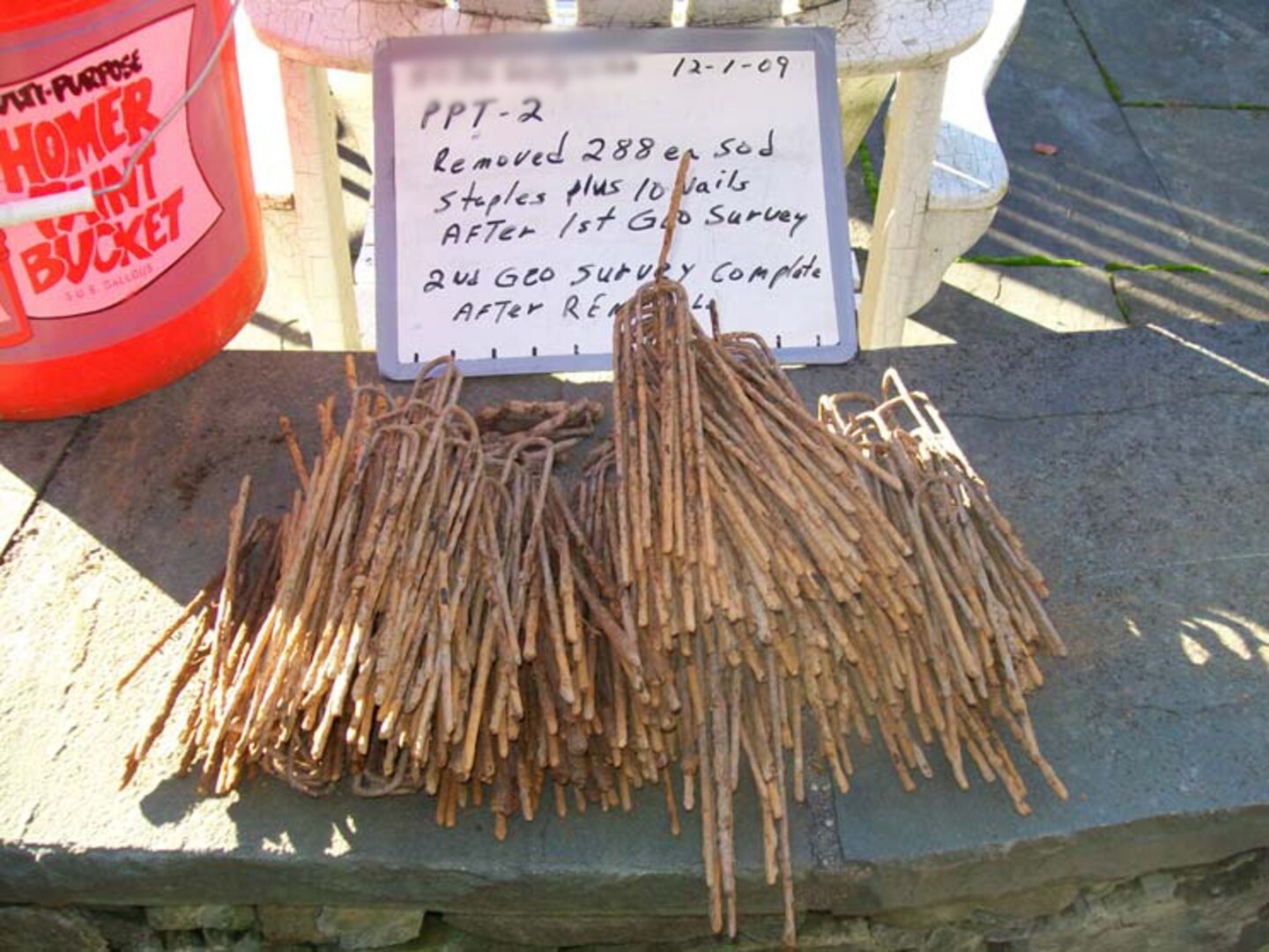 Sod staples and nails unearthed by U.S. Army Corps of Engineers contractors during a munitions investigation at a private property at the Spring Valley Formerly Used Defense Site in Washington, D.C., Dec. 1, 2009. "False digs" of cultural debris like this are common when looking for potentially buried munitions, and the U.S. Army Corps of Engineers is currently using the latest Advanced Geophysical Classification technology in Spring Valley to reduce the number of false digs during ongoing munitions investigations work.