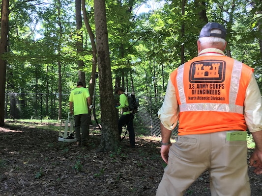 U.S. Army Corps of Engineers Project Manager Alex Zahl looks on as contractors use Advanced Geophysical Classification technology to identify potentially buried munitions items on a municipally owned parcel of property along the Dalecarlia Parkway within the boundaries of the Spring Valley Formerly Used Defense Site in Washington, D.C., Sept. 6, 2018. The Corps is using the latest in geophysical mapping technology to reduce the amount of unnecessary digs during its munitions investigation where cultural debris like scrap metal, nails and other construction debris make up the majority of the digs on site.