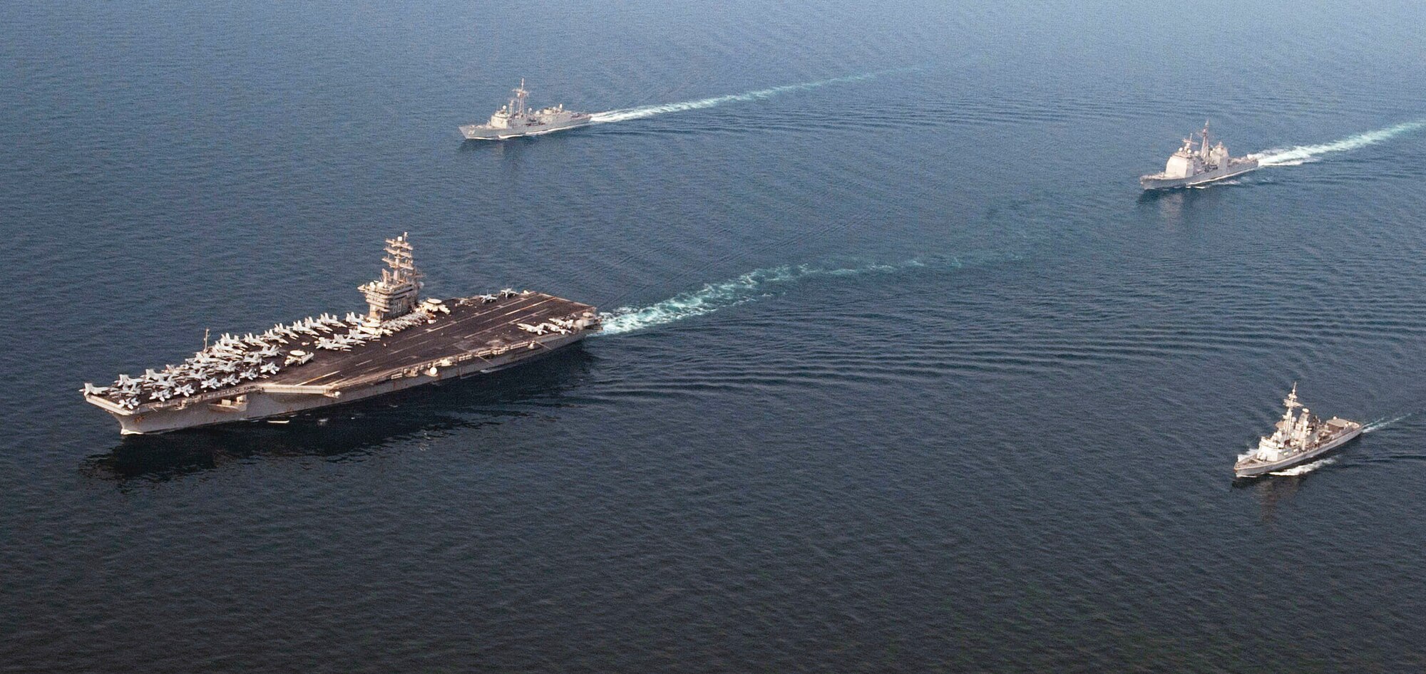 The aircraft carrier USS Nimitz (CVN 68), the Ticonderoga-class guided-missile cruiser USS Princeton (CG 59), the French Navy air defense destroyer FS Jean Bart (D615) and the Royal Australian Navy frigate HMAS Newcastle (FFG 06) conduct a formation group sail demonstrating combined interoperability and multinational partnership in support of Commander, Task Force 50 operations, Sept. 8, 2017, in the Arabian Gulf. Program Executive Office Digital at Hanscom Air Force Base, Mass., is working toward better integration of the intelligence, surveillance and reconnaissance systems that inform combatant commanders by coding a shared infrastructure that joins the services separate Distributed Common Ground Systems into a single hub for information. (U.S. Navy photo by Mass Communication Specialist 3rd Class Ian Kinkead)
