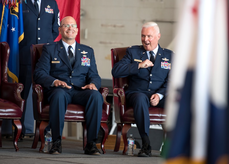 Col. Scott McLaughlin, incoming 349th Air Mobility Wing commander, jokes with Col. Raymond Kozak, outgoing 349th AMW commander, during a change of command ceremony at Travis Air Force Base, California, June 1, 2019. McLaughlin is scheduled to assume command of the 349th AMW from Kozak on June 9.