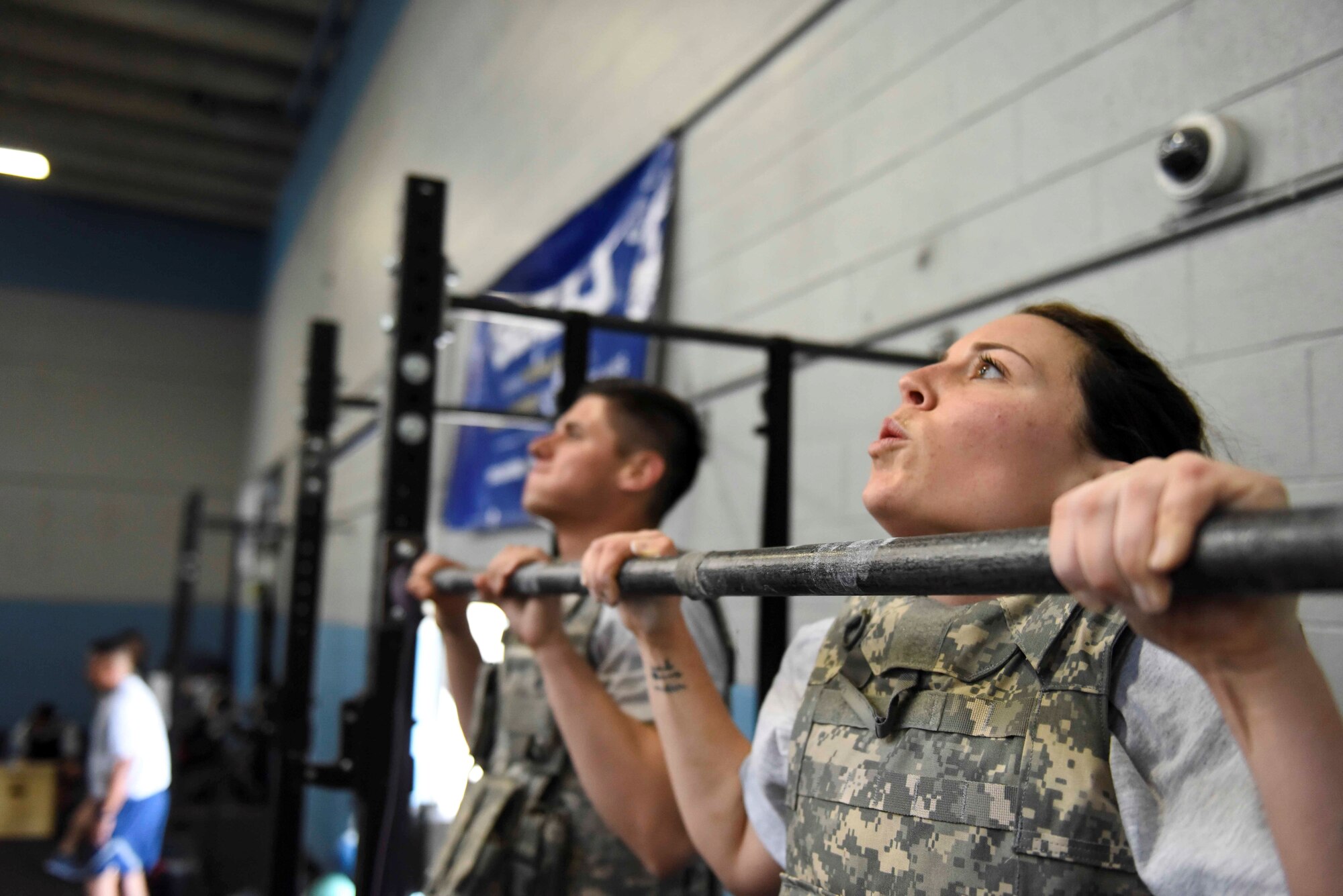 Senior Airman Jenny Medel and Senior Airman Logan Medel complete a pull-up during the 419th Fighter Wing’s annual Murph Challenge