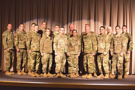 Eighteen Soldiers from the 174th Cyber Protection Team stand
on the stage of the Utah National Guard's Draper headquarters
during their departure ceremony Jan. 2, 2019.
