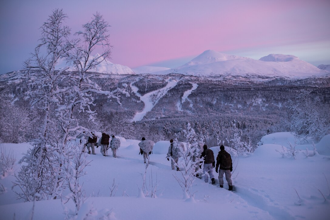 Marines and soldiers patrol at dusk.