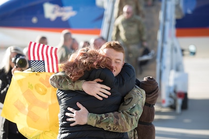 Members of the 65th Field Artillery greet the awaiting crowd upon their return from a Middle East deployment Jan 31 to the Rolland R. Wright Air Base, Salt Lake City.