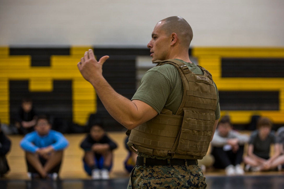 U.S. Marines assigned to Marine Air Control Squadron (MACS) 1 participate in MACS-1's Marine Week at Ron Watson Middle School in Yuma, Ariz., March 27, 2019. The first day of Marine Week consisted of opening remarks from the MACS-1 Commanding Officer, Lt. Col. David Hughes, and demonstrations of the Marine Corps Martial Arts Program (MCMAP) techniques. (U.S. Marine Corps photo by Cpl. Sabrina Candiaflores)