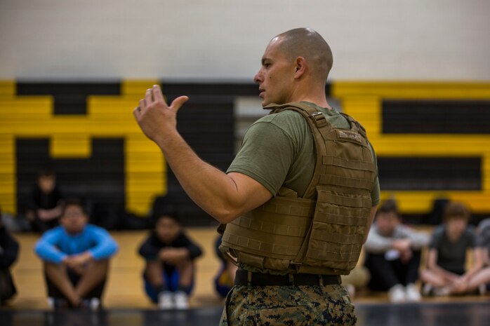 U.S. Marines assigned to Marine Air Control Squadron (MACS) 1 participate in MACS-1's Marine Week at Ron Watson Middle School in Yuma, Ariz., March 27, 2019. The first day of Marine Week consisted of opening remarks from the MACS-1 Commanding Officer, Lt. Col. David Hughes, and demonstrations of the Marine Corps Martial Arts Program (MCMAP) techniques. (U.S. Marine Corps photo by Cpl. Sabrina Candiaflores)