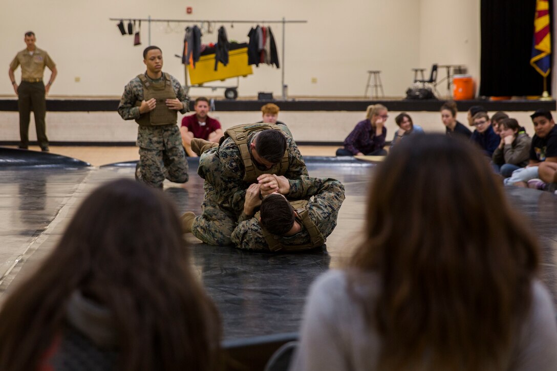 U.S. Marines assigned to Marine Air Control Squadron (MACS) 1 participate in MACS-1's Marine Week at Ron Watson Middle School in Yuma, Ariz., March 27, 2019. The first day of Marine Week consisted of opening remarks from the MACS-1 Commanding Officer, Lt. Col. David Hughes, and demonstrations of the Marine Corps Martial Arts Program (MCMAP) techniques. (U.S. Marine Corps photo by Cpl. Sabrina Candiaflores)