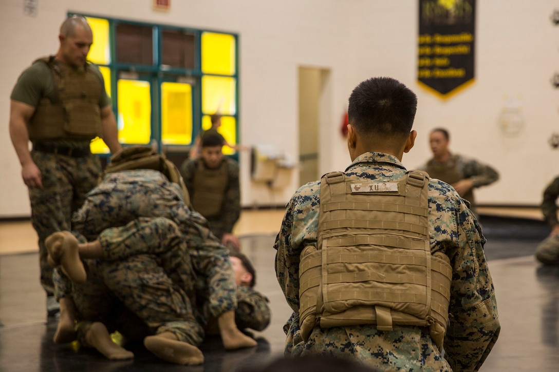 U.S. Marines assigned to Marine Air Control Squadron (MACS) 1 participate in MACS-1's Marine Week at Ron Watson Middle School in Yuma, Ariz., March 27, 2019. The first day of Marine Week consisted of opening remarks from the MACS-1 Commanding Officer, Lt. Col. David Hughes, and demonstrations of the Marine Corps Martial Arts Program (MCMAP) techniques. (U.S. Marine Corps photo by Cpl. Sabrina Candiaflores)