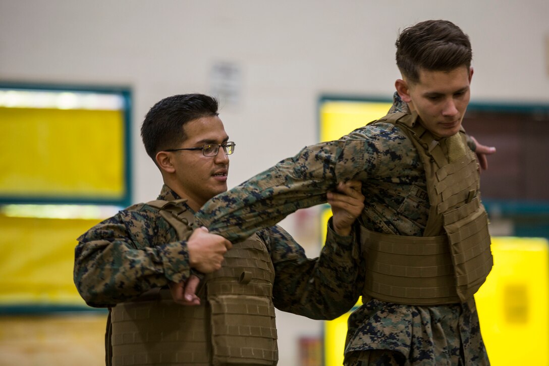 U.S. Marines assigned to Marine Air Control Squadron (MACS) 1 participate in MACS-1's Marine Week at Ron Watson Middle School in Yuma, Ariz., March 27, 2019. The first day of Marine Week consisted of opening remarks from the MACS-1 Commanding Officer, Lt. Col. David Hughes, and demonstrations of the Marine Corps Martial Arts Program (MCMAP) techniques. (U.S. Marine Corps photo by Cpl. Sabrina Candiaflores)